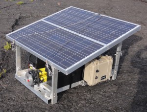 This portable “power” platform is designed to be slung by helicopter to temporary monitoring sites on Hawaiian volcanoes. The platform is being used at Webcam sites and at Kïlauea’s summit to measure activity of the lava lake in Halema‘uma‘u Crater—a continuously recording gravity meter and an experimental camera for measuring sulfur dioxide gas (shown here). The platform can also be used for other types of monitoring instruments. Photo courtesy of USGS/HVO