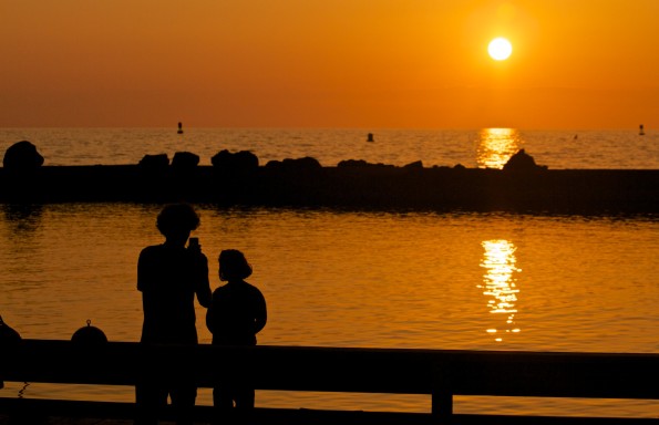 Casey Yundt takes a sunset photo of daughter Izabella, six-years-old, at Kawaihae Harbor Thursday afternoon (May 22). Photography Baron Sekiya | Hawaii 24/7