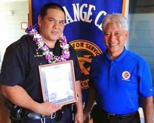 Hilo Exchange Club President Andy Iwashita presents an 'Officer of the Month' award to Officer Dwight Walker.