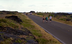 Visitors to Hawaii Volcanoes National Park walk along the closed section of Chain of Craters Road leading to the lava flow which cut-off access to Kaimu. Hawaii 24/7 File Photo