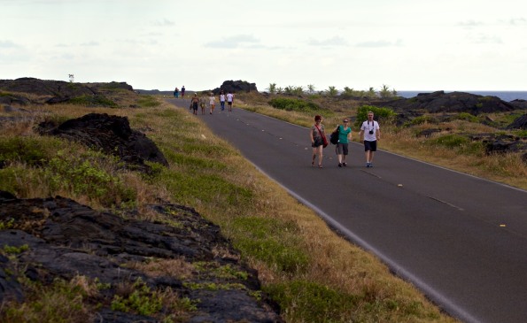 Visitors to Hawaii Volcanoes National Park walk along the closed section of Chain of Craters Road leading to the lava flow which cut-off access to Kaimu. Hawaii 24/7 File Photo