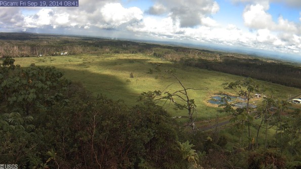 Webcam image taken at 8:41 a.m. Friday (Sep 19) of Kilauea's June 27th Flow and the Lower East Rift Zone. The camera is positioned near Kapoho looking Northwest. From left to right on the horizon, one can see Puʻu ʻŌʻō vent near the left edge of the image, the gas plume from Halemaʻumaʻu crater (when clear enough), with Mauna Loa and Mauna Kea farther to the right. The advancing front of the June 27th lava flow is burning vegetation and sending smoke aloft in the left center of the image. Photo courtesy of USGS/HVO