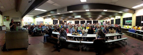 Steve Brantley of the USGS/HVO briefs the audience in the Pahoa High School Cafeterial during the lava flow update meeting Thursday night (Jan 8). Panoramic photo by Baron Sekiya | Hawaii 24/7
