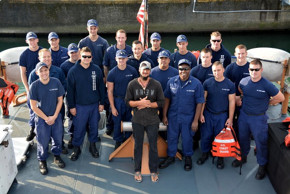Crew members aboard Coast Guard Cutter Kiska pose with a distressed kayaker rescued from sea approximately 19 miles northeast of Kohala, Big Island, Jan. 14, 2015. The 38-year-old man left Maui en route Big Island when he became lost and called for assistance using his cell phone. Photo courtesy USCG