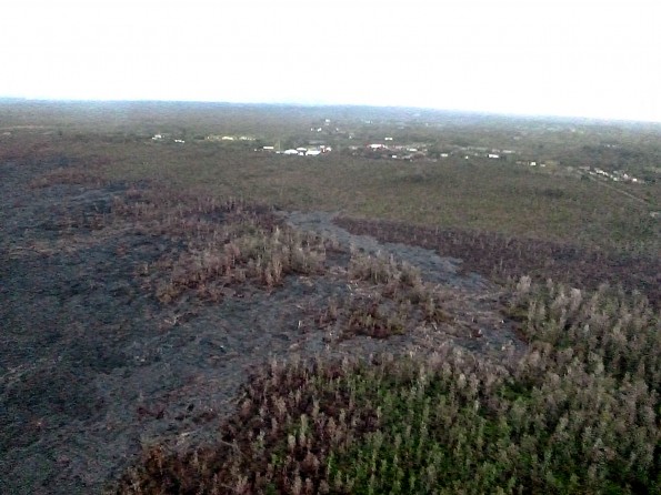 Image from the Friday, March 13, 2015 overflight of the Kilauea June 27th Lava Flow. The view from the south flow margin, looking down slope towards Hwy 130, Pahoa Marketplace, and Apaa Street. Photo courtesy of Hawaii County Civil Defense