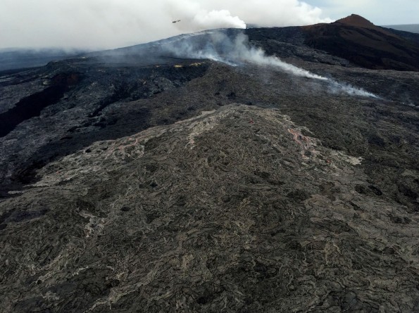 Active surface flows on the northeast flank of Pu‘u ‘Ō‘ō on March 12, 2015. The activity is a continuation of a breakout that began on February 21, which diverted lava from the tube system and helped to starve the supply of lava to the June 27th flow front near Pāhoa. This breakout on Kīlauea is still active and has now reached 2.5 km (1.6 mi) northeast of Pu‘u ‘Ō‘ō, but does not pose an immediate hazard to any community. USGS photo.
