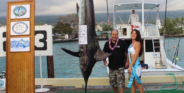 Angler Darryl Bradly of Ahipara Game Fish Club, New Zealand, celebrates his 408-pound Pacific blue marlin catch with Miss Billfish 2015 Cheri Lavoie. The team was fishing aboard Hooked Up with Capt. Jim Wigzell. (Hawaii 24/7 photo by Karin Stanton)
