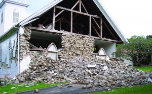 Damage to the Kalāhikiola Congregational Church in Kapa‘au, Hawai‘i, caused by the 2006 Kīholo Bay earthquake and aftershocks clearly shows why taking cover inside a building (Drop! Cover! Hold on!) is safer than trying to run outside or stand in a doorway when the ground shakes. Collapse of the exterior wall would have severely injured (or worse) anyone trying to run through or stand in the doors of the church during the quakes. USGS photo.