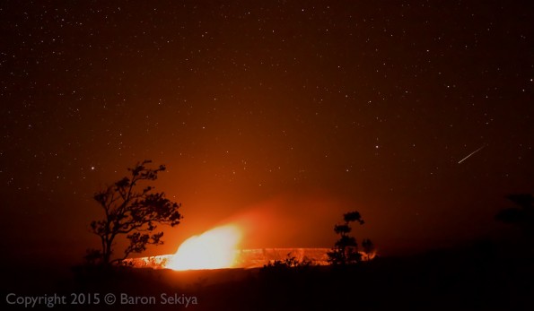 Kilauea Caldera with the glow from the active lava lake in Halemaumau's Overlook Crater as a shooting star cuts across the sky on the right. Monday, January 4, 2016. Photo by Baron Sekiya | Hawaii 24/7