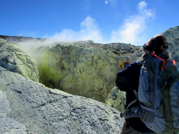 A USGS Hawaiian Volcano Observatory chemist conducts thermal imaging measurements as part of a geochemical survey on Mauna Loa's upper Southwest Rift Zone in March 2016. Areas like the one shown here can indicate where gases are escaping from magma at depth. USGS photo.