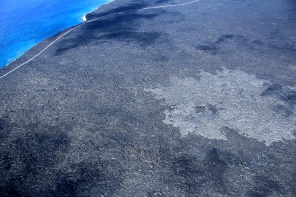 The flow front remains active on the coastal plain, but has only moved about 60 m (~200 ft) closer to the ocean in the past three days. As of midday on July 15, the slow-moving pahoehoe is roughly 870 m (~0.5 mi) from the ocean. Activity upslope continues to widen the flow margins. The light gray surface in this image is the new pahoehoe of the 61G flow. Photo taken Friday, July 15, 2016 courtesy of USGS/HVO