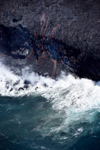 Less than 24 hours after first reaching the sea in the early morning hours of July 26, lava spilling over the sea cliff and into the ocean had started building a foundation of loose lava fragments on which a new lava delta can form. Lava deltas are extremely dangerous because they can collapse into the ocean without warning, triggering explosions that hurl rocks on and off shore, and sending waves of scalding water onto the coast. The area of active lava pouring over this sea cliff is about 20 m (66 ft) wide and the cliff is about 20 m (66 ft) high. USGS photo.