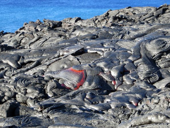 This morning, slow-moving pāhoehoe lava toes and lobes continued to break out from the active flow that crossed the "emergency route" gravel road on Kīlauea Volcano's south flank. Viewing these active breakouts requires a long (8-10 miles, round trip) and hot hike. It is essential for anyone attempting the hike to carry 2-3 quarts of drinking water per person. Sturdy shoes and sun protection (hat, sunglasses, sunscreen) are highly recommended. Early morning or late evening hikers should also carry a flashlight and extra batteries. For more safety info, please visit http://pubs.usgs.gov/fs/2000/fs152-00/ and https://www.nps.gov/havo/learn/photosmultimedia/lava-safety-video.htm Photo taken Saturday, July 30, 2016 courtesy of USGS/HVO