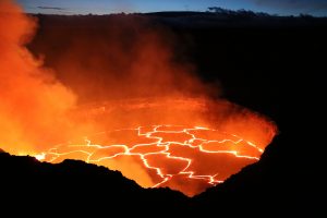 A view of the lava lake in Halemaʻumaʻu Crater at dusk, taken from the rim of Halemaʻumaʻu (closed to the public due to volcanic hazards). The view is towards the northwest, with the broad summit of Mauna Loa near the top of the photograph. The lake was 34 meters (112 feet) below the Overlook crater rim at this time. Photo taken Wednesday, September 28, 2016 courtesy of USGS/HVO