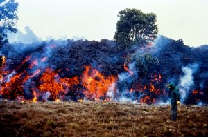 A USGS Hawaiian Volcano Observatory geologist monitored the advance of an ‘a‘ā lava flow on April 6 during the 1984 Mauna Loa eruption. This flow was about 4 m (13 ft) high and advancing at a rate of 50 m (55 yards) per hour. Lava reached within 6 km (4 mi) of Hilo city limits before the 22-day-long eruption ended on April 15. USGS photo by P.W. Lipman.