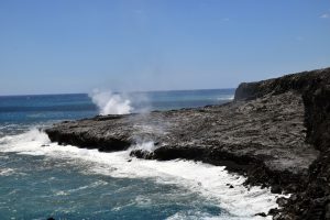 Kīlauea Volcano’s Kamokuna lava delta on October 6, 2017. Multiple streams of lava entering the ocean on both sides of the delta created small plumes of laze (lava haze). The visible part of the delta, which is deceptively stable, was built by many small lava flows accumulating on an unstable foundation of unconsolidated volcanic rock fragments. USGS photo by L. DeSmither.