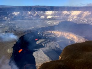 On January 8, 2018, Kīlauea Volcano’s summit lava lake level was 38 m (125 ft) below the rim of “Overlook crater,” the small crater that formed above the active vent in Halemaʻumaʻu. The lava lake continuously emits elevated levels of sulfur dioxide gas and erupts small, but measurable, amounts of Pele’s hair and other ash-sized tephra (airborne lava fragments) that accumulate on the rim of Halemaʻumaʻu (lower right) and areas downwind of the lake. USGS photo by J. Sutton.