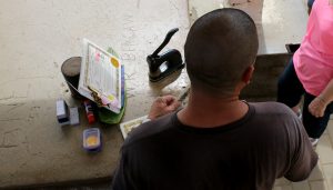 A man sells unpermitted certificates at Diamond Head and was cited by DLNR Division of Conservation and Resources (DOCARE) officers Thursday (March 8). DLNR Photo.