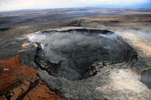 For the past month and a half, the crater floor of Pu‘u ‘Ō‘ō has experienced ongoing uplift, which has generated cracks on the crater floor. These cracks are cutting through both recent lava flows (darker color) and older flows on the crater floor. Photo taken Monday, April 23, 2018 courtesy of U.S. Geological Survey