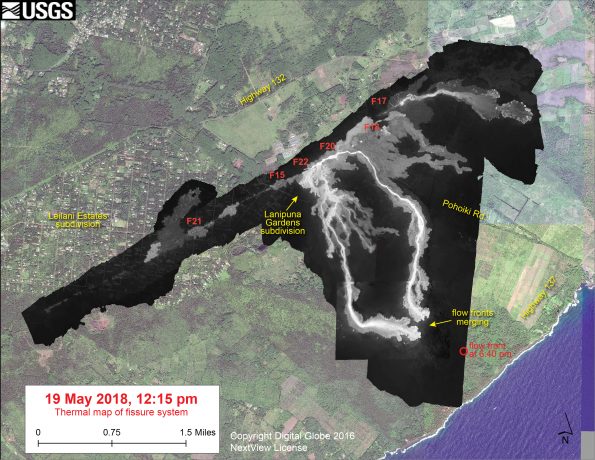 This thermal map shows the fissure system and lava flows as of 12:15 pm on Saturday, May 19. The two primary lava flows originate from the Fissure 20-22 area, and crossed Pohoiki Road over the past day. The flow front position based on a 6:40 pm update is shown by the red circle. The black and white area is the extent of the thermal map. Temperature in the thermal image is displayed as gray-scale values, with the brightest pixels indicating the hottest areas. The thermal map was constructed by stitching many overlapping oblique thermal images collected by a handheld thermal camera during a helicopter overflight of the flow field. The base is a copyrighted color satellite image (used with permission) provided by Digital Globe.