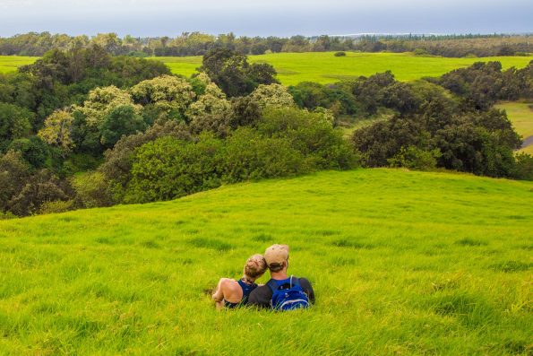 A couple enjoying the view from Pu‘u o Lokuana cindercone in the Kahuku Unit. NPS Photo/Janice Wei 