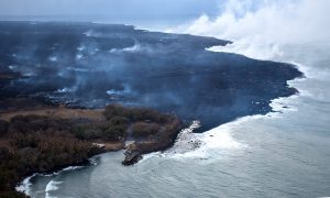 During this morning's overflight, the ocean entry laze plume was being blown offshore, allowing this fairly clear view (looking northeast) of the Pohoiki boat ramp at Isaac Hale Beach Park. Incandescent (glowing red) spots of lava can be seen within the flow field beyond the boat ramp. HVO geologists also observed a few oozes of lava on or near the western flow margin, but all appeared weak as of 6:00 a.m. HST. Photo taken Thursday, August 2, 2018 courtesy of U.S. Geological Survey
