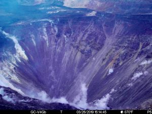 This image was taken at 3:14 p.m., Tuesday, March 26, 2019, from a camera on the west rim of Kilauea Caldera. The camera is looking East towards the bottom of the newly enlarged Halemaʻumaʻu crater, although the deepest part of the crater is not visible from this vantage point. The crater from left to right (roughly NNE to SSW) is approximately 1 km (0.6 mi) across. The depth of the crater in the visible image from the rim is several hundred meters. Photo from USGS/HVO